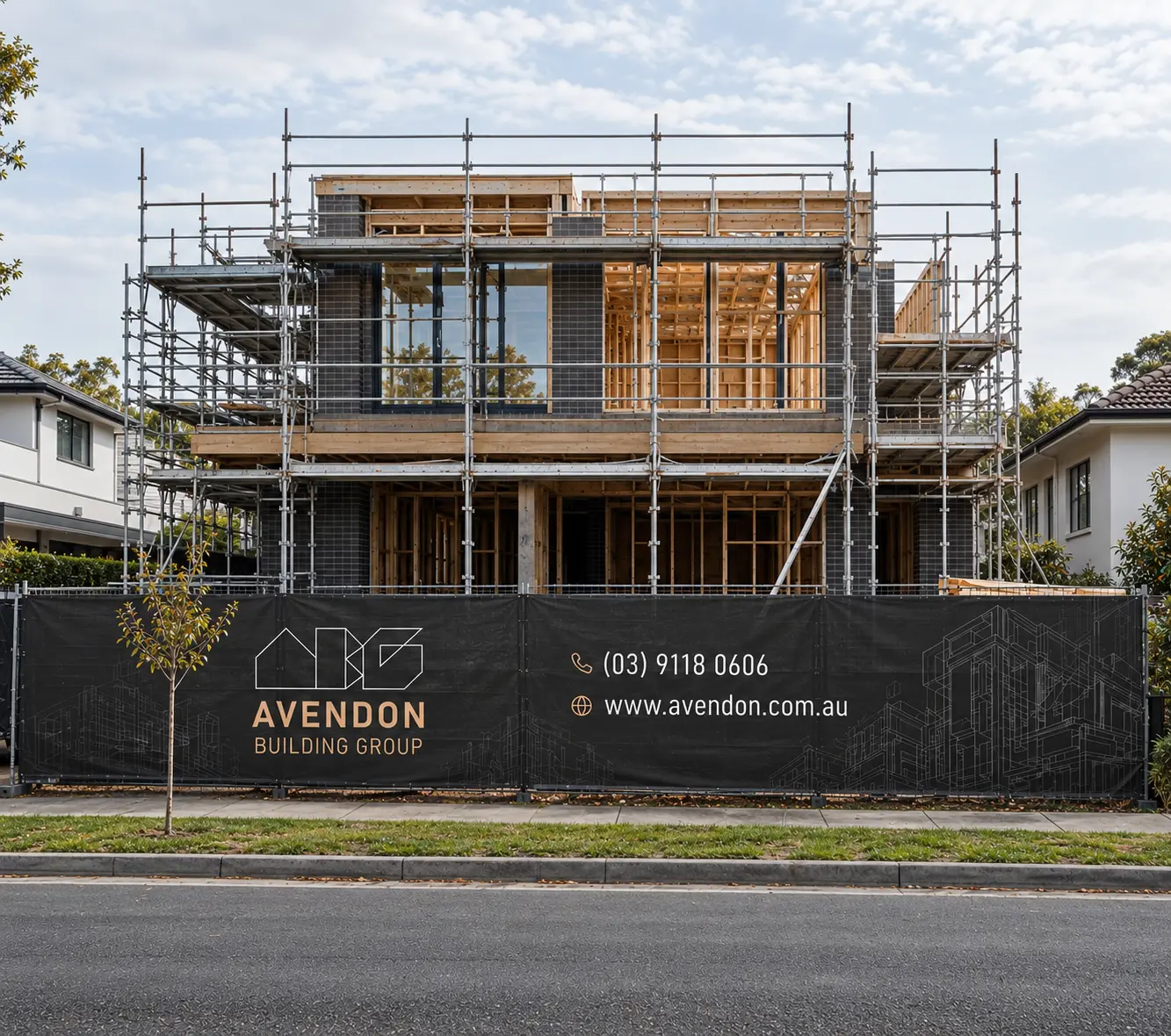 Front elevation of an Avendon Building Group residential construction site with scaffolding and branded fencing