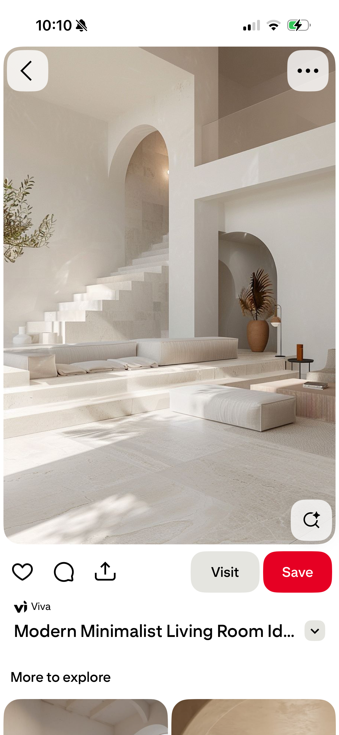 Bright minimalist living room with a sculptural staircase and arched opening